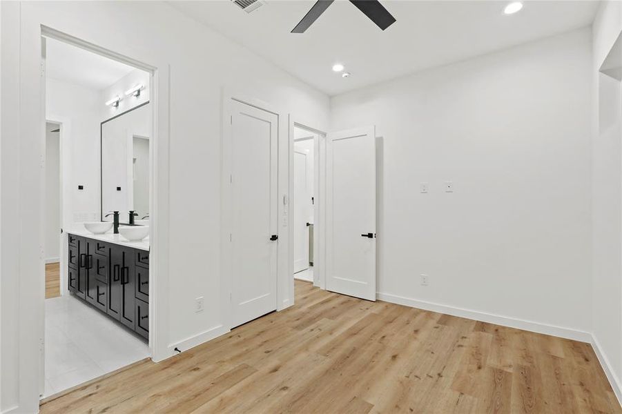 Unfurnished room with light hardwood / wood-style flooring and sink