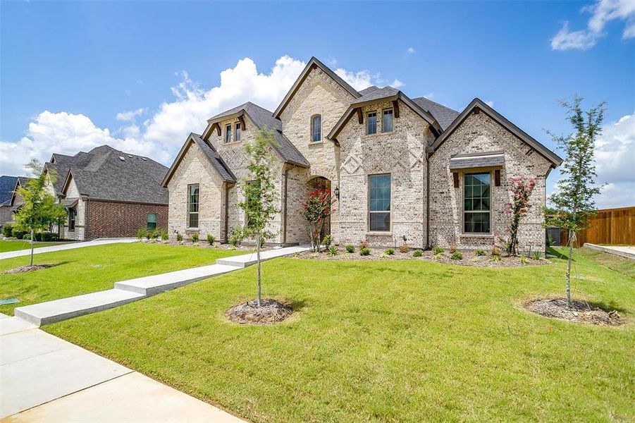 French country style house featuring a front yard