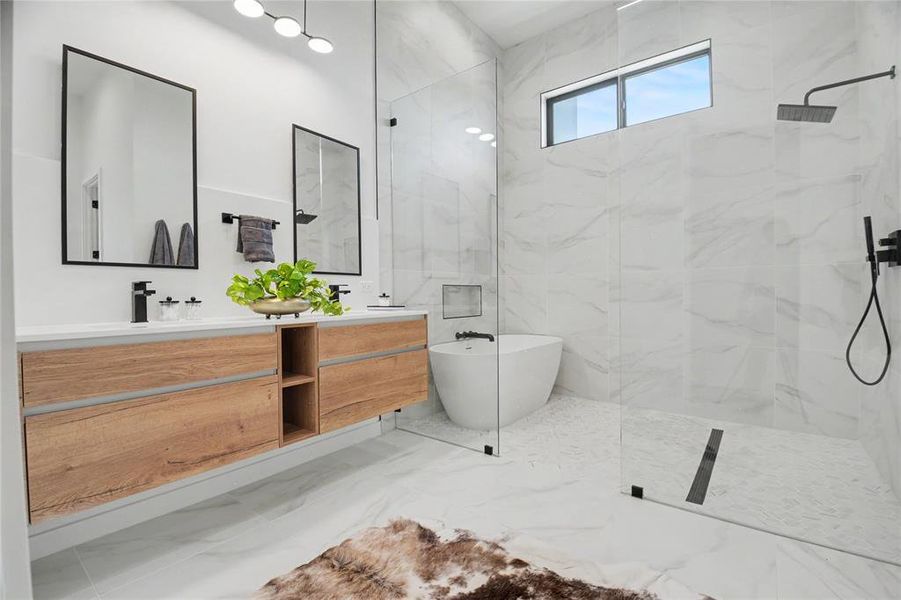 A deep soaking tub and rain shower evoke a spa setting.