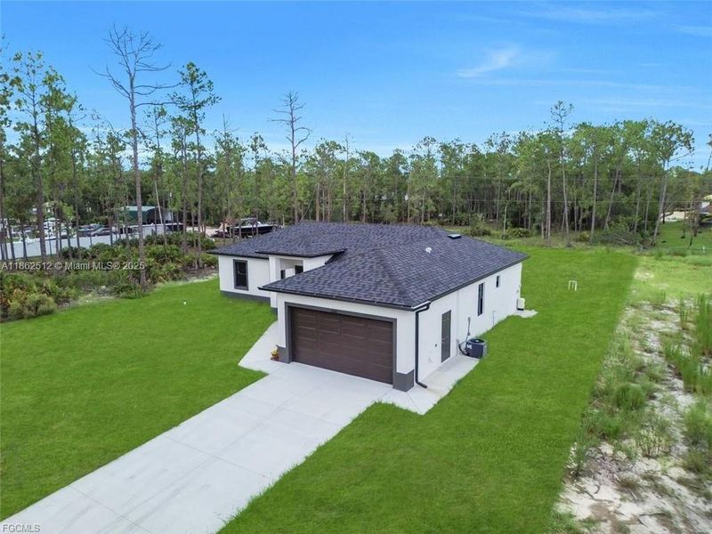 Front exterior of a new home in , Lehigh Acres, FL, highlighting curb appeal (Image 14).
