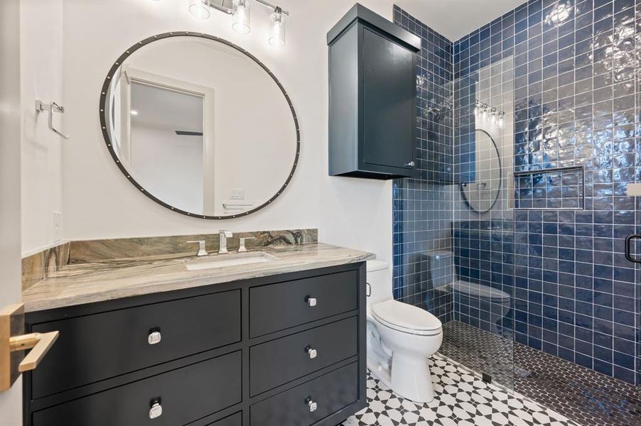 Bathroom featuring vanity and a shower stall