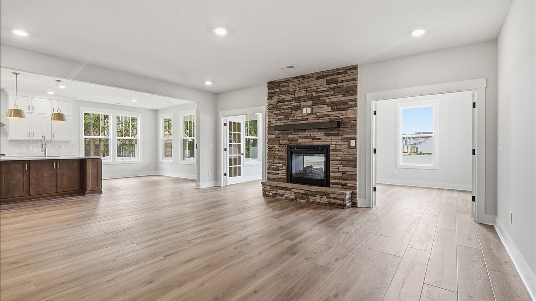 Elegant family room featuring hardwood flooring, large windows, and thoughtful architectural detail in Greenville, SC