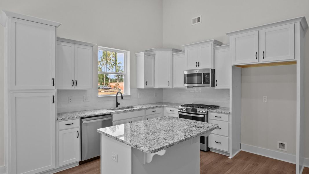 Accomplished kitchen layout with a compact island, perfect for prep and casual dining