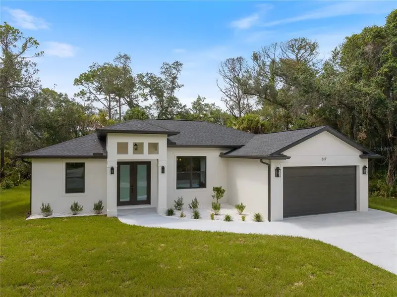Front exterior of a new home in , Port Charlotte, FL, highlighting curb appeal (Image 18).