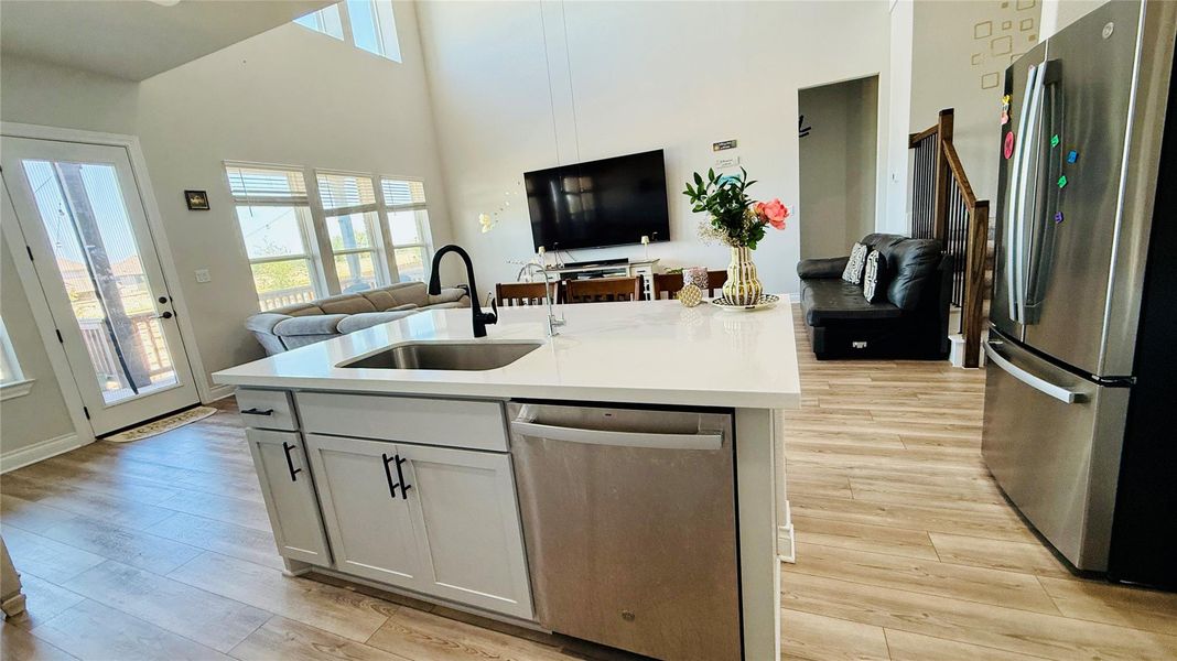 A sun-filled kitchen island with a sink offers ample counter space for culinary endeavors.
