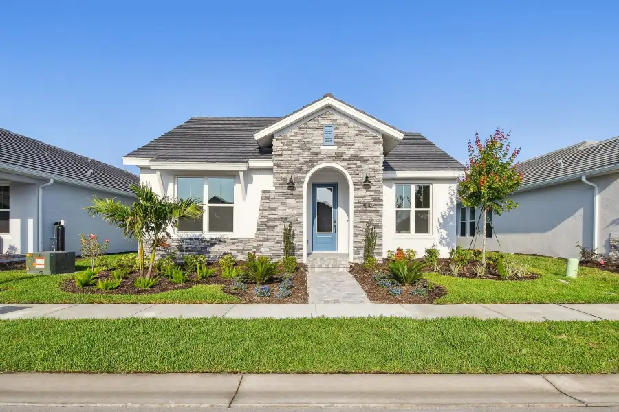 Representative exterior photo of a completed home built from the The Mapleton by David Weekley Homes in Vistera of Venice – Cottage Series, Nokomis, FL (Image 13). Representative exterior photo of a completed home built from the The Mapleton by David Weekley Homes in Vistera of Venice – Cottage Series, Nokomis, FL (Image 13).