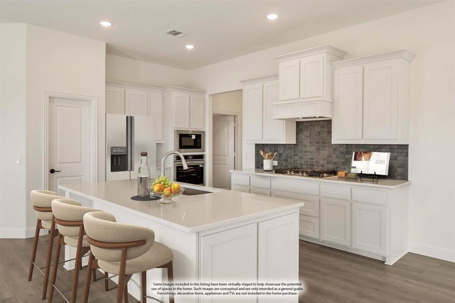 Kitchen with white cabinets, center island with seating, gray tile backsplash, and stainless steel appliances Kitchen with white cabinets, center island with seating, gray tile backsplash, and stainless steel appliances