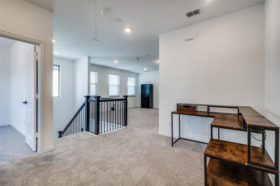 Hallway featuring carpet floors