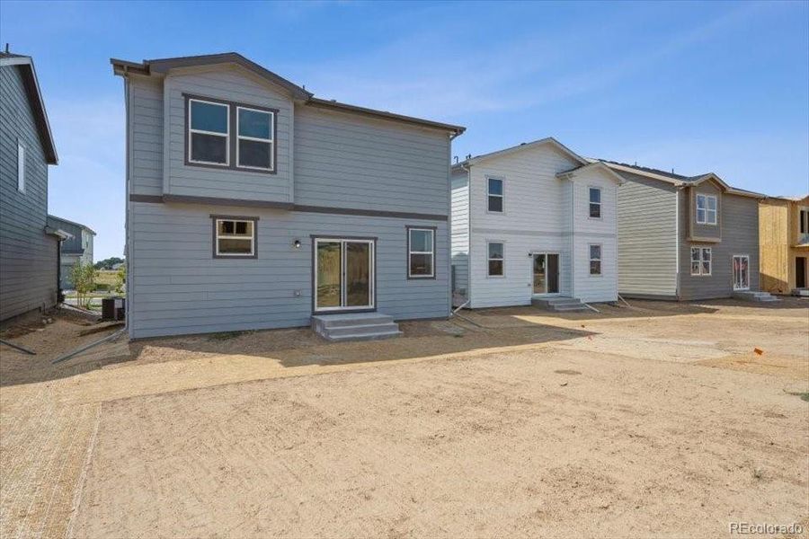 Front exterior of a new home in Farmlore, Brighton, CO, highlighting curb appeal (Image 16).