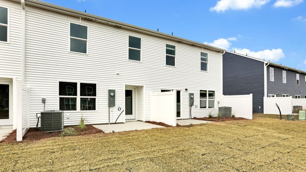 Exterior details and patio area of a home in Grayson Park Townhomes, Leland (Image 2).