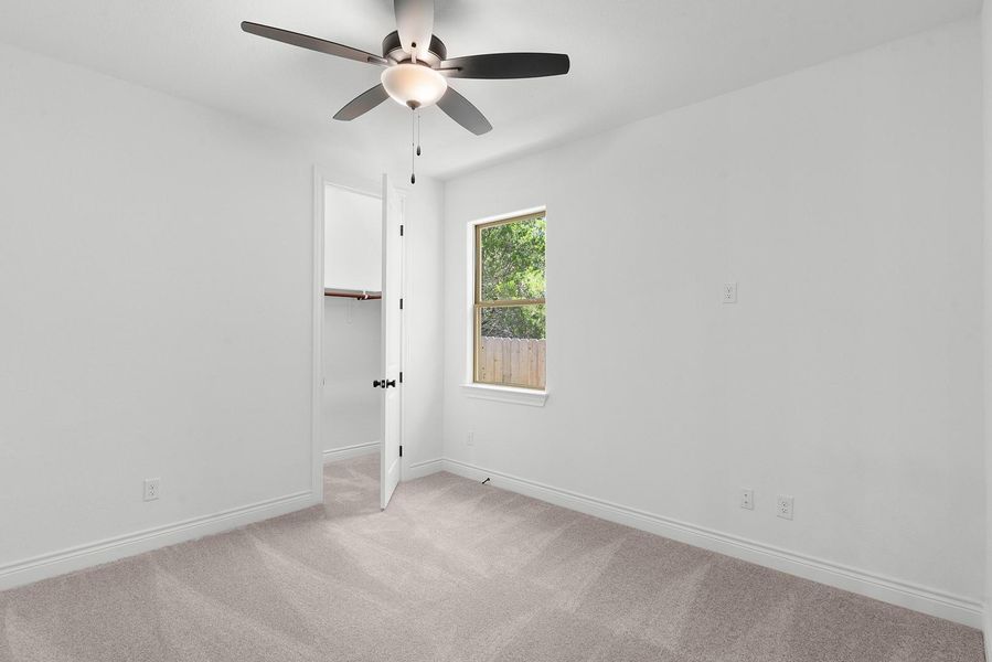 A well-lit bedroom with fresh carpet offers a tranquil retreat.
