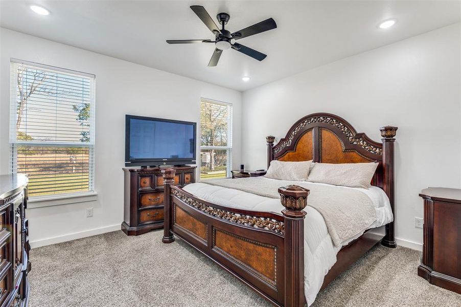 Bedroom featuring light carpet, ceiling fan, and recessed lighting