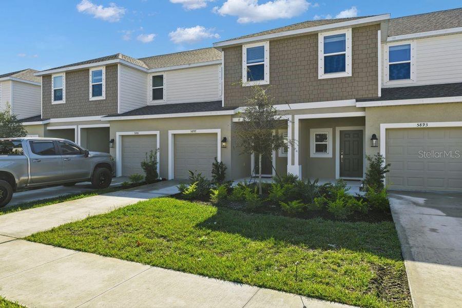 Front exterior of a new home in Vinterra Townhomes, Nokomis, FL, highlighting curb appeal (Image 1). Front exterior of a new home in Vinterra Townhomes, Nokomis, FL, highlighting curb appeal (Image 1).