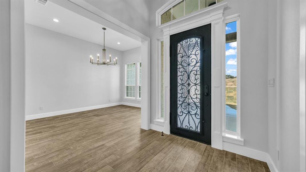 Foyer with light hardwood / wood-style flooring and ceiling fan