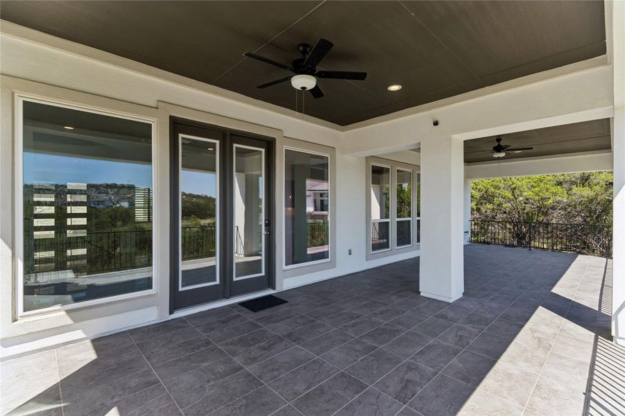 A spacious, covered deck provides an idyllic setting for outdoor gatherings amidst natural surroundings.