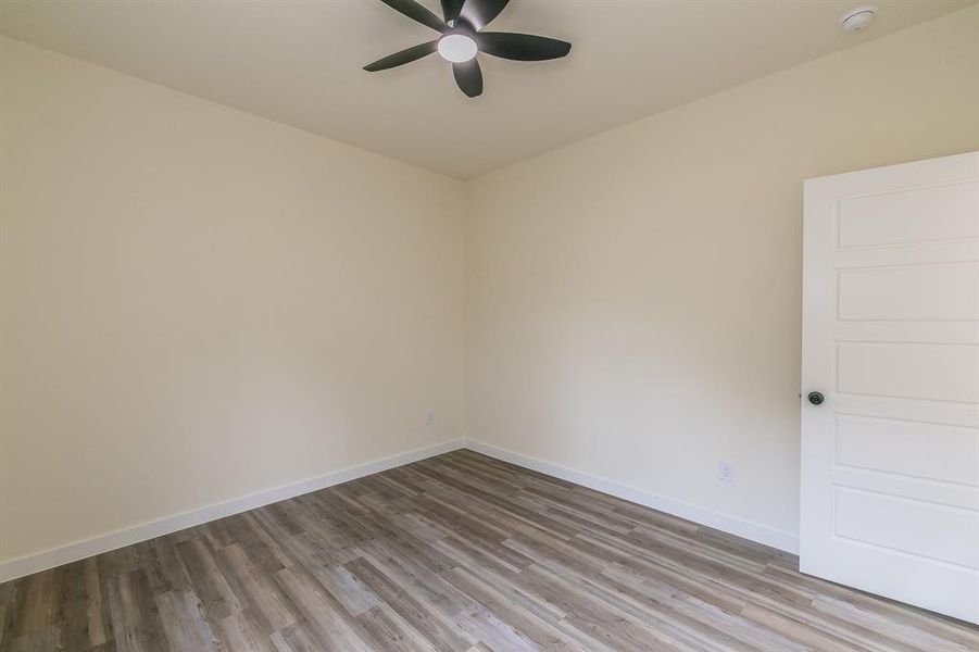 Unfurnished room featuring ceiling fan and light hardwood / wood-style floors