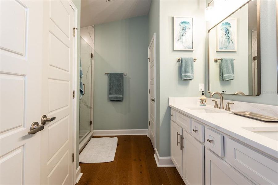 ensuite primary bathroom with quartz countertops