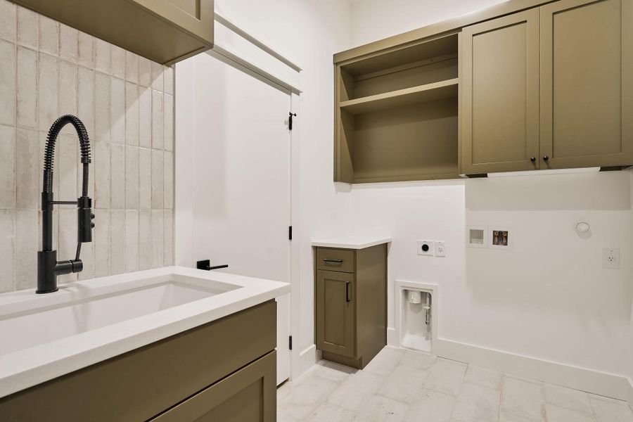 Laundry area with electric dryer hookup, cabinet space, hookup for a washing machine, and gas dryer hookup Laundry area with electric dryer hookup, cabinet space, hookup for a washing machine, and gas dryer hookup