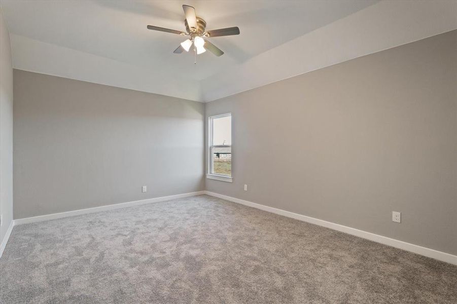 Unfurnished room with carpet flooring and ceiling fan Unfurnished room with carpet flooring and ceiling fan