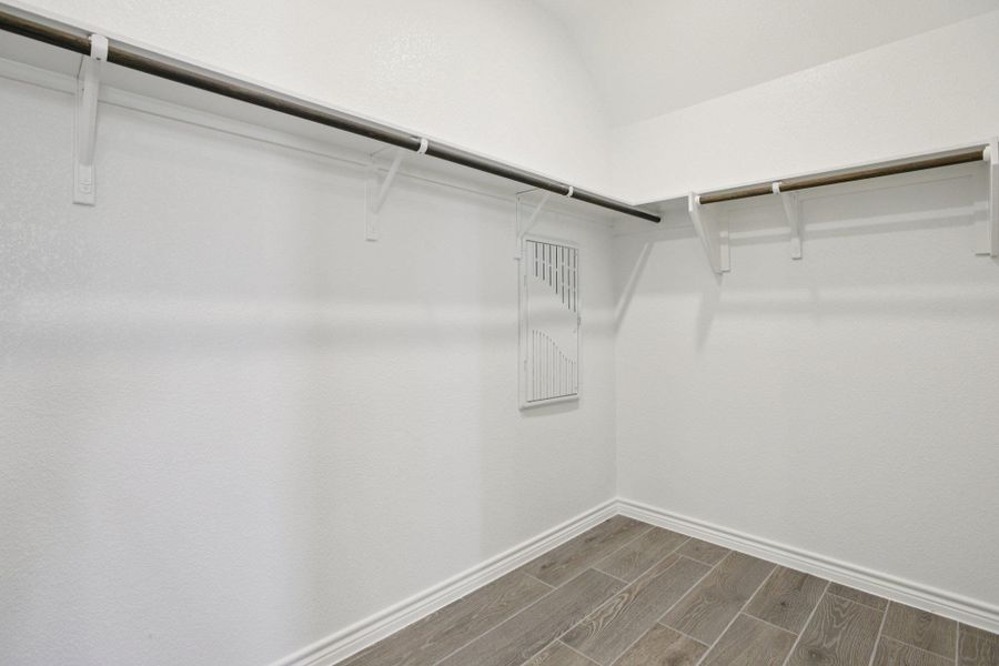 Walk in closet with wood tiled floors