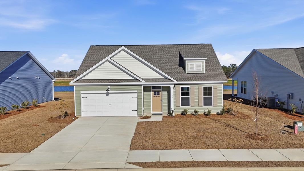 View of front facade featuring a shingled roof, driveway, and an attached garage View of front facade featuring a shingled roof, driveway, and an attached garage