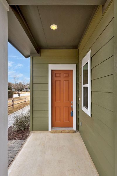 Doorway to property featuring a porch
