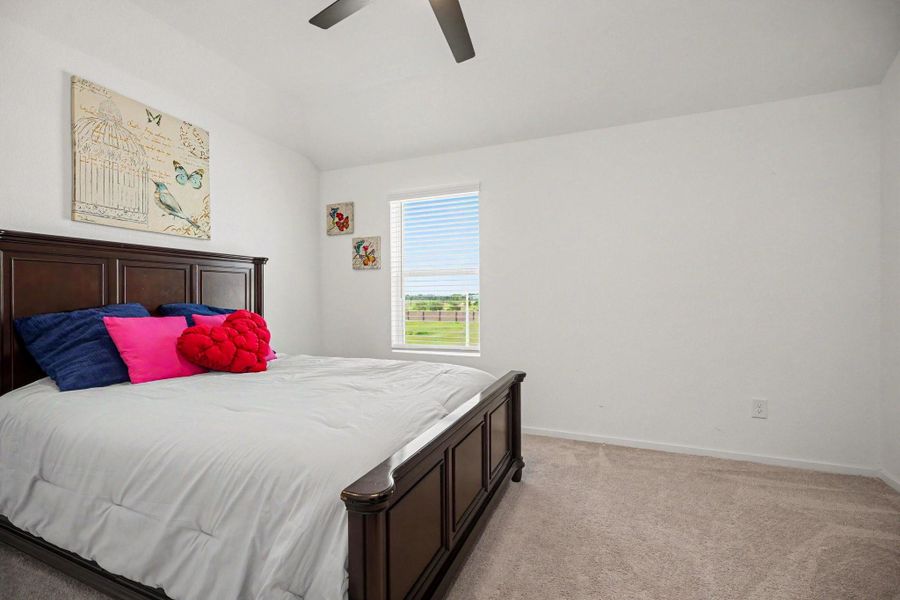 Well-sized secondary bedroom with vaulted ceilings, plush carpeting, and a spacious layout. Well-sized secondary bedroom with vaulted ceilings, plush carpeting, and a spacious layout.