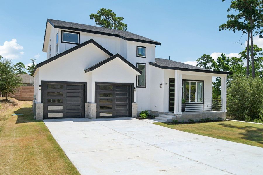 Clean modern lines and a concrete driveway lead to this striking two-story home. Clean modern lines and a concrete driveway lead to this striking two-story home.