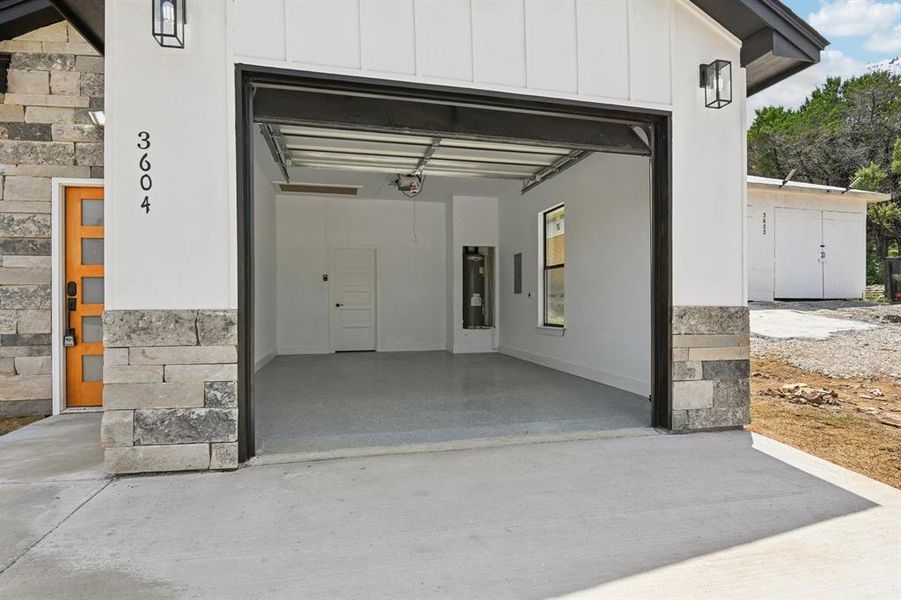 Garage with electric water heater and concrete driveway Garage with electric water heater and concrete driveway