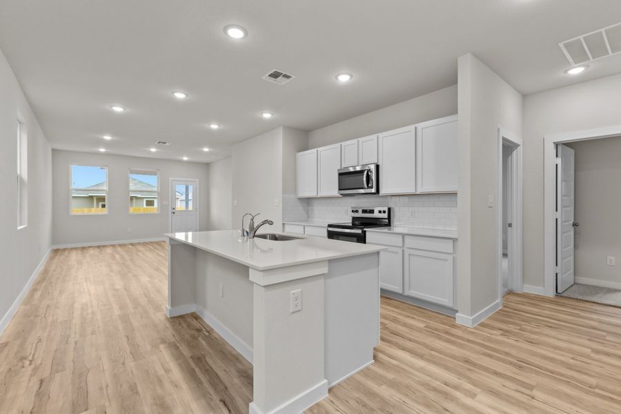 A kitchen with white cabinets. A kitchen with white cabinets.