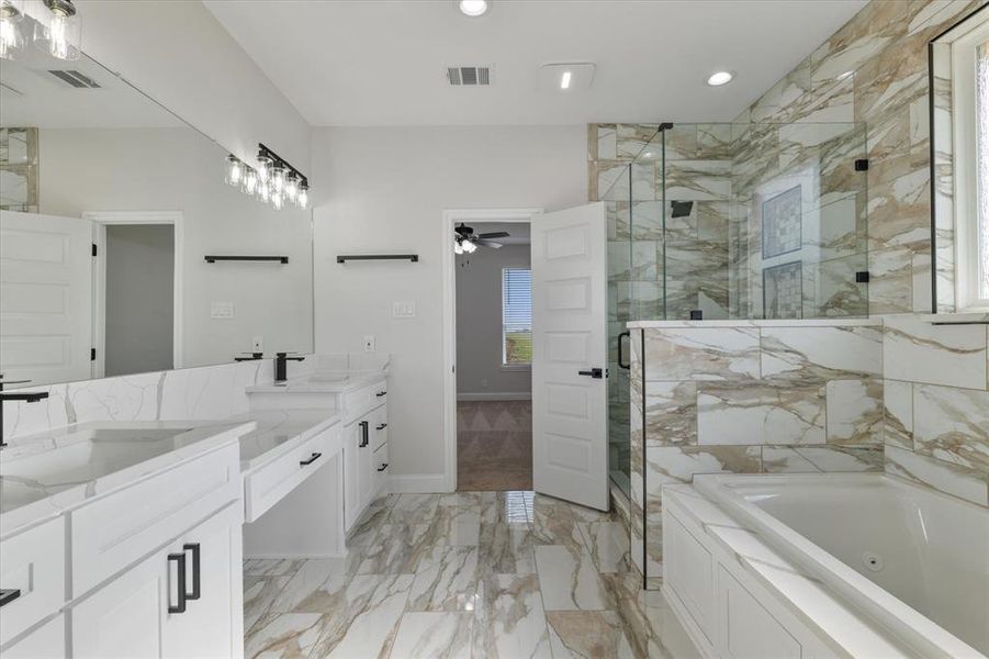 Bathroom featuring marble finish floor, a shower stall, visible vents, and a tub with jets