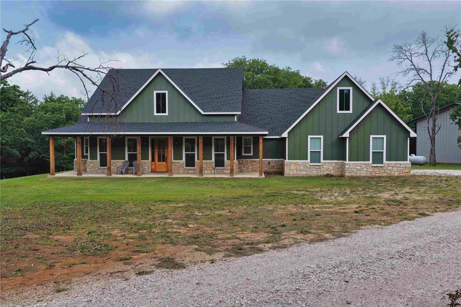 Green board and batten siding with stone veneer accents