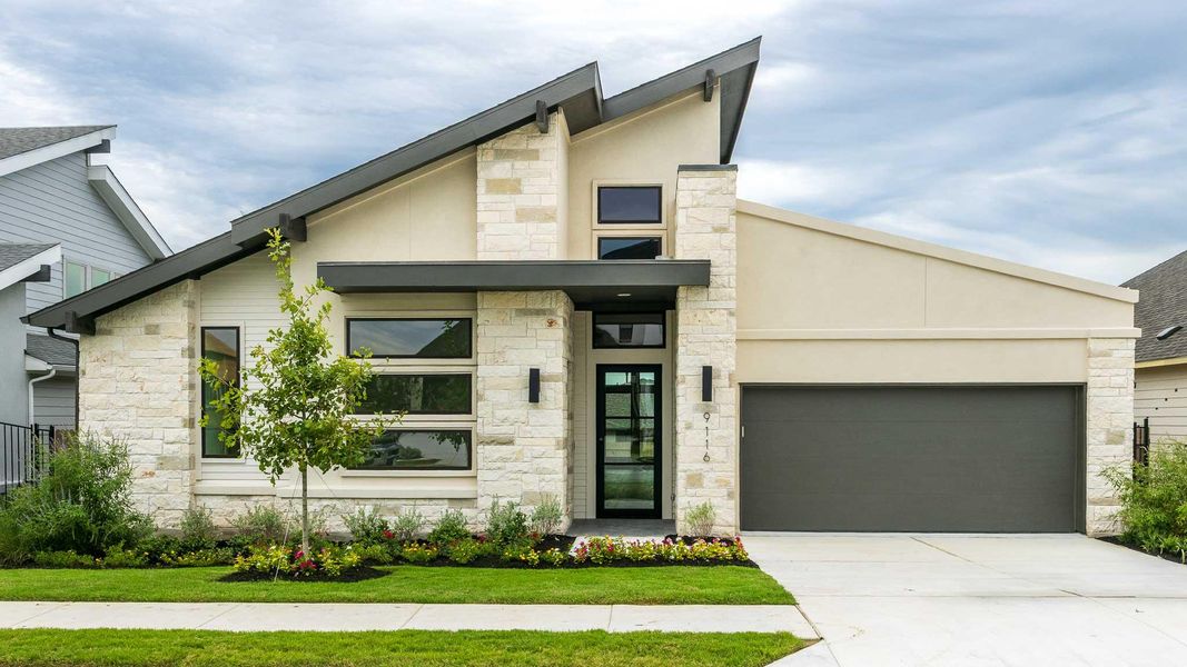 Contemporary house featuring stone siding, an attached garage, concrete driveway, and stucco siding Contemporary house featuring stone siding, an attached garage, concrete driveway, and stucco siding