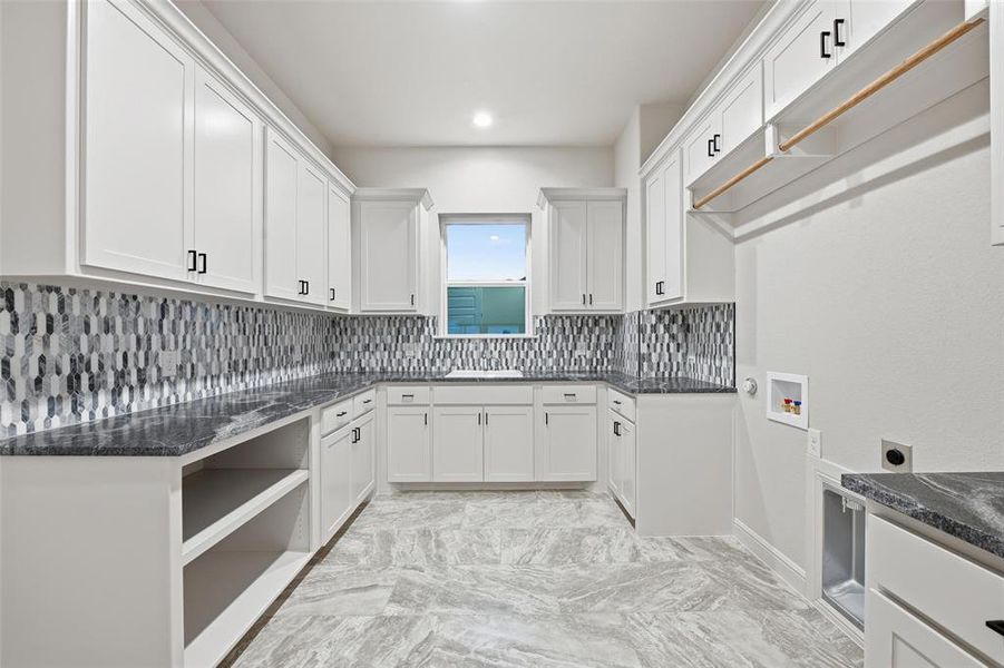 Laundry room with hookup for a washing machine, cabinet space, electric dryer hookup, and recessed lighting Laundry room with hookup for a washing machine, cabinet space, electric dryer hookup, and recessed lighting
