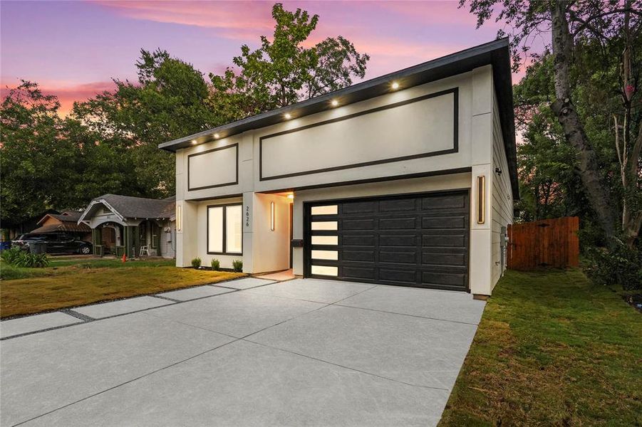 Contemporary house with driveway, a garage, and stucco siding Contemporary house with driveway, a garage, and stucco siding