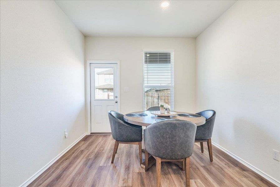 Dining area off kitchen with recessed lighting and LVP Dining area off kitchen with recessed lighting and LVP
