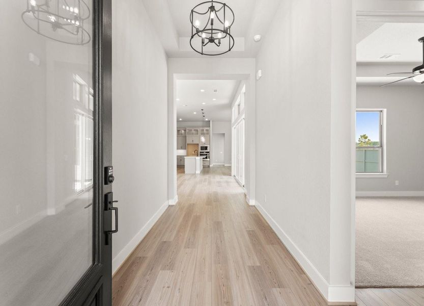 The Entry Reveals a 12ft. Ceiling and Luxury Vinyl Plank Flooring The Entry Reveals a 12ft. Ceiling and Luxury Vinyl Plank Flooring