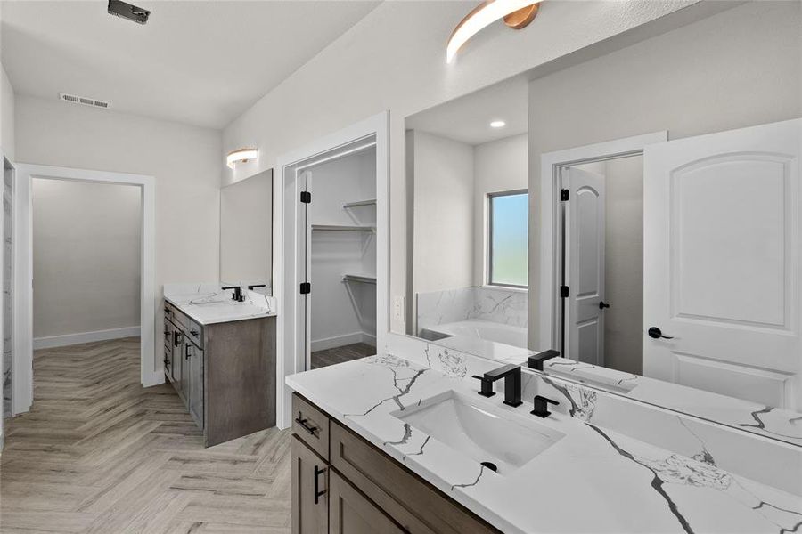 Bathroom featuring vanity and parquet floors