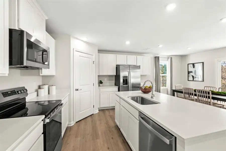 Representative furnished interior of a home built from the Woodford by Ryan Homes in Oakwood Trace, Fairburn (Image 4).