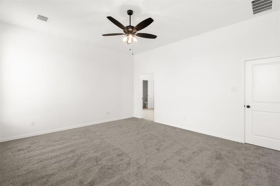 Spare room featuring carpet floors and a ceiling fan Spare room featuring carpet floors and a ceiling fan