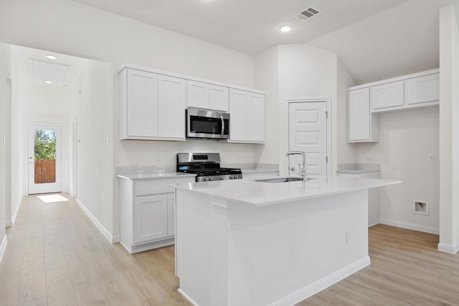 Kitchen in the Cypress home plan by Trophy Signature Homes - REPRESENTATIVE PHOTO