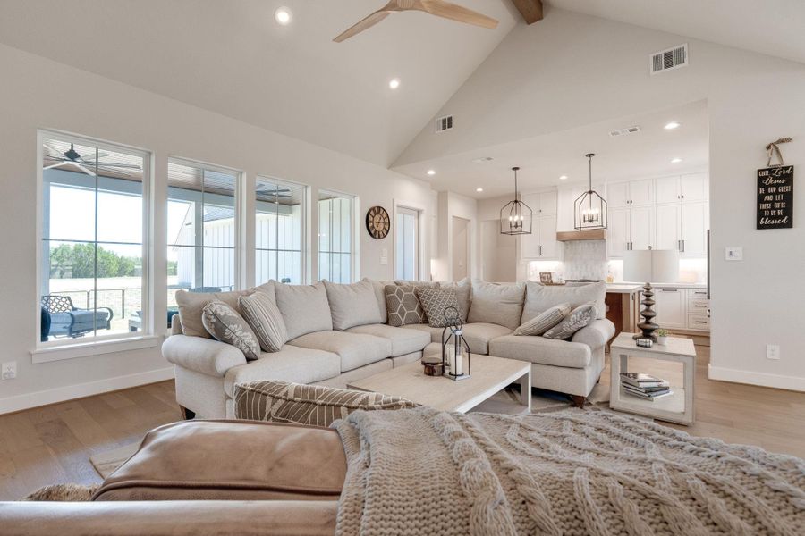Living area featuring ceiling fan, light wood-type flooring, and recessed lighting