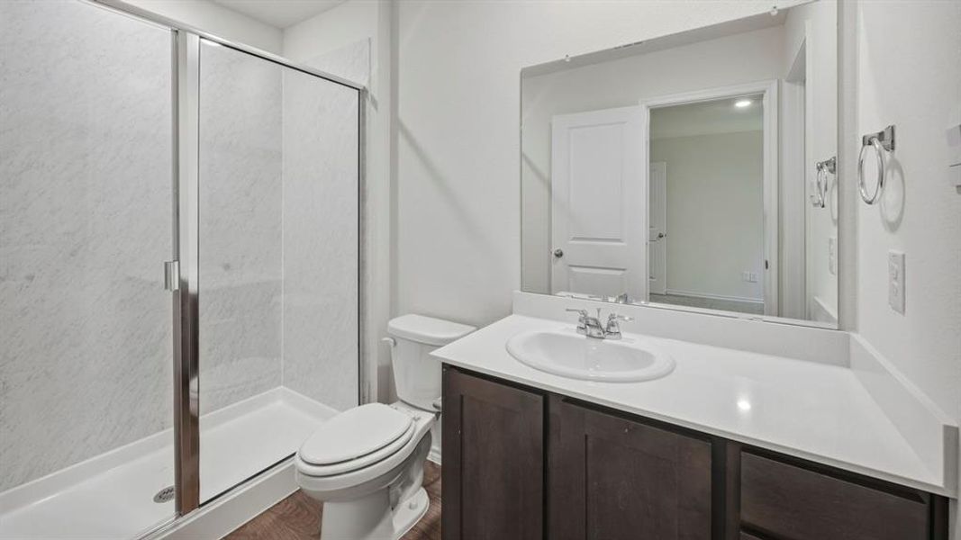 Bathroom with a shower stall and vanity