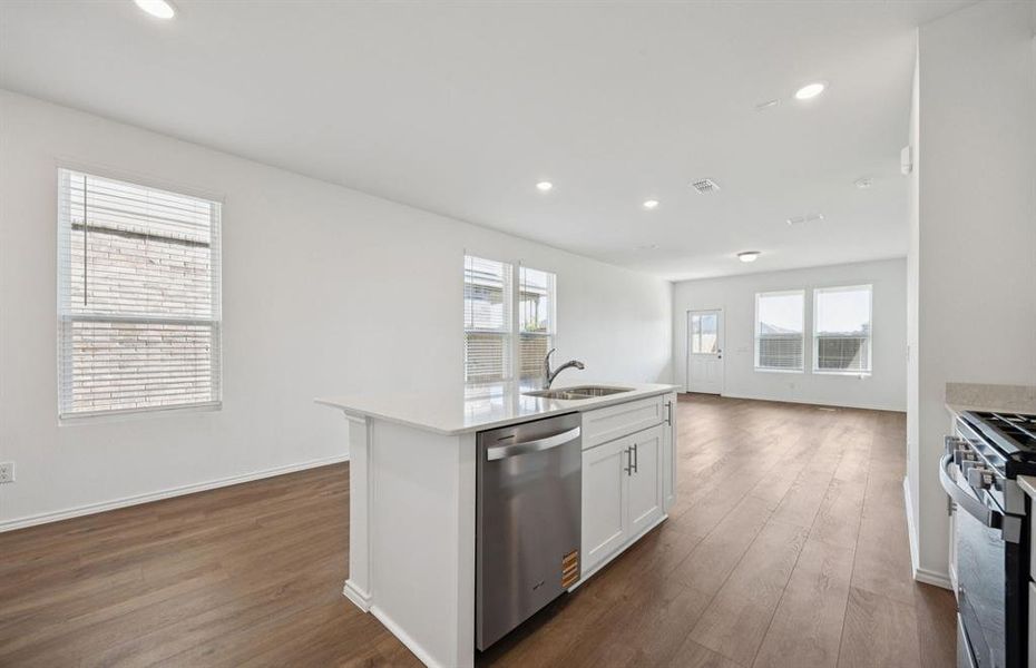 Large island overlooking gathering room and dining areas Large island overlooking gathering room and dining areas