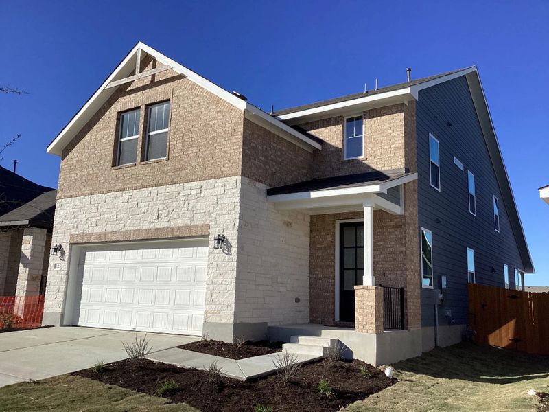 Front exterior of a new home in The Homestead at Lariat, Liberty Hill, TX, highlighting curb appeal (Image 16).