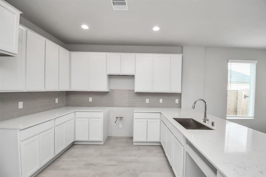 The kitchen is a culinary haven, featuring granite countertops, a tile backsplash, stainless steel appliances (To be Installed) and 42” upper cabinets.