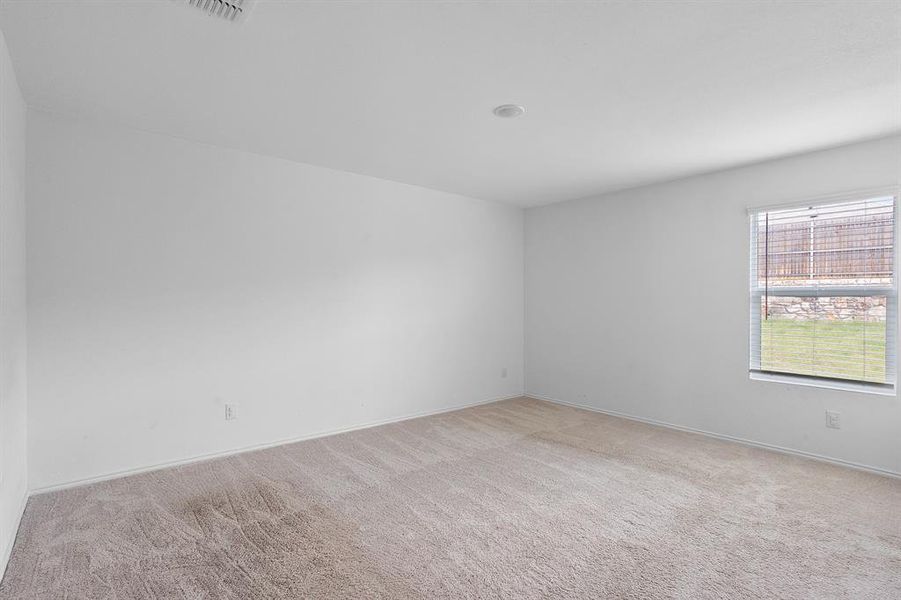 Spare room with light colored carpet and baseboards