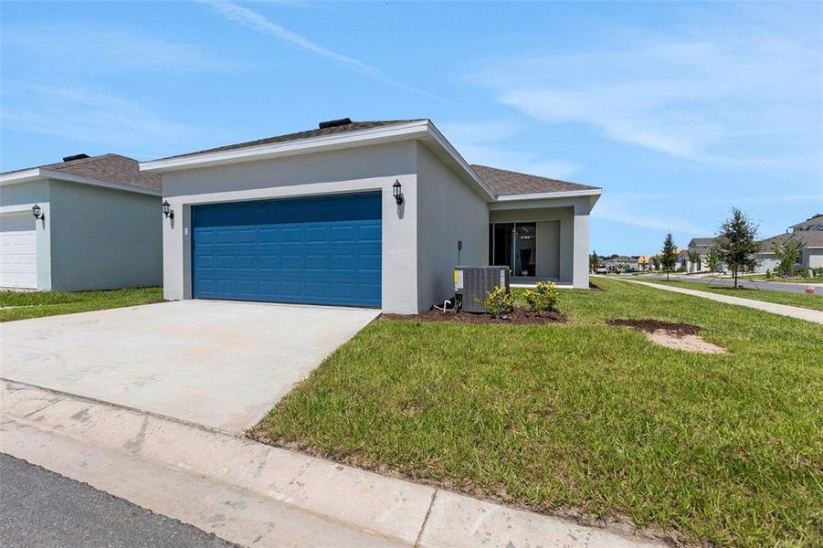 Front exterior of a new home in Crossroads at Kelly Park, Apopka, FL, highlighting curb appeal (Image 32).