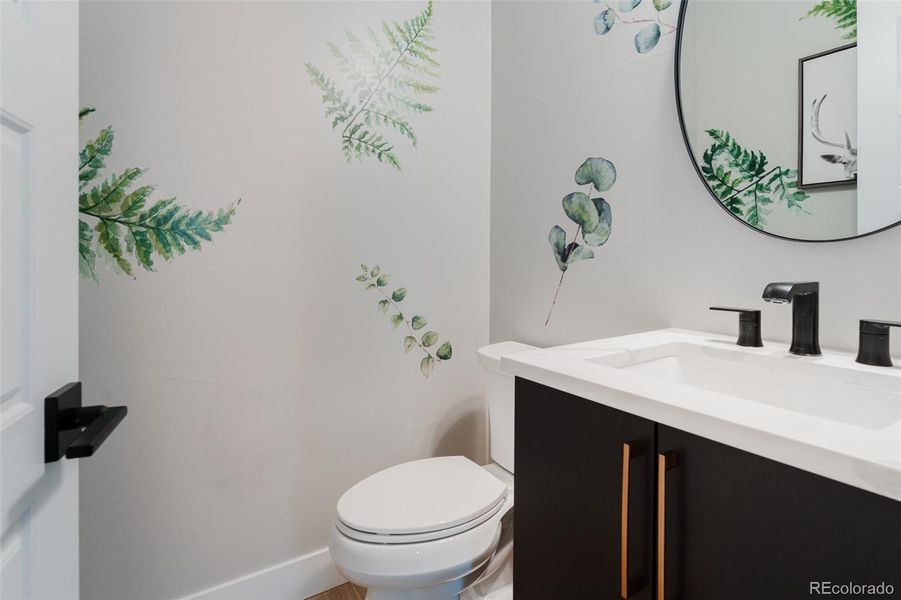 The enchanting powder room serves as a tranquil oasis, offering a refreshing escape with its soothing ambiance.