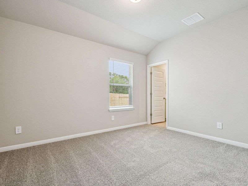 Unfurnished room with light colored carpet and vaulted ceiling Unfurnished room with light colored carpet and vaulted ceiling